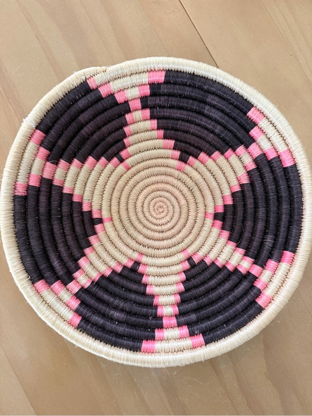 African Handwoven Decorative Basket tray in Black, cream, & bright Pink.